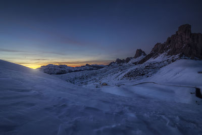 Scenic view of snowcapped mountains against sky during sunset