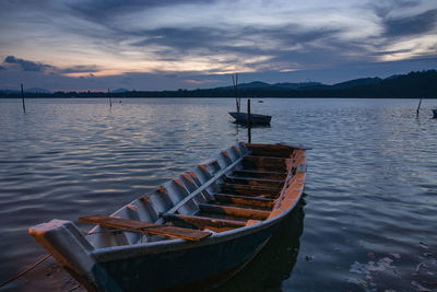 Boats in lake at sunset