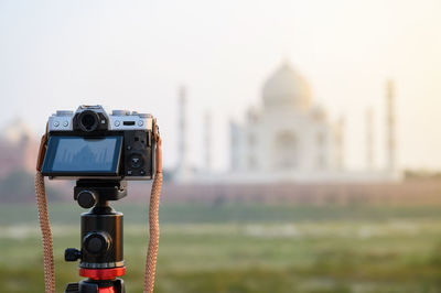 Close-up of camera against building