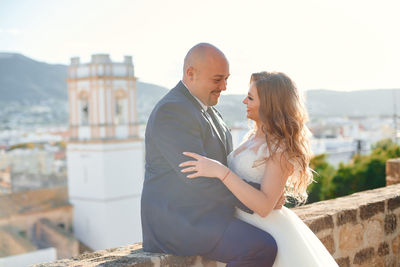 Side view of couple standing outdoors