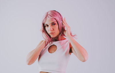 Portrait of beautiful woman standing against white background