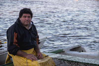 Portrait of man sitting in sea