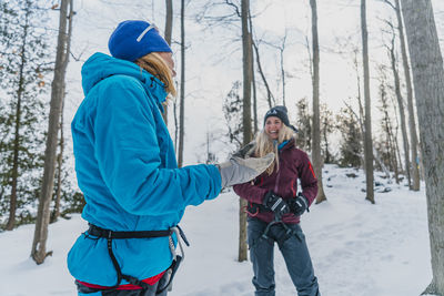 Friends laughing before climb outside