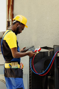 Rear view of man working at construction site