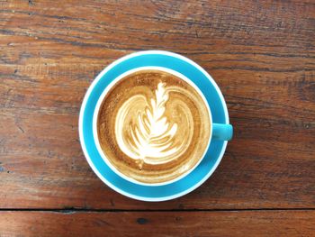 Directly above shot of cappuccino served on table