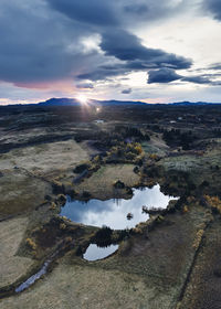 Beautiful sunset over mountainous terrain with lake