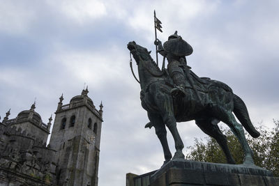 Low angle view of statue against sky