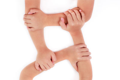 Midsection of woman touching hand over white background