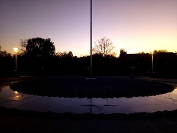 Silhouette of street lights at dusk