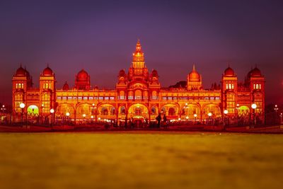 Illuminated building against sky at night