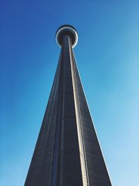 Low angle view of cn tower against clear blue sky in city
