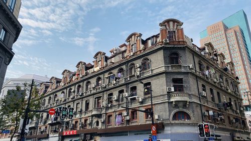 Low angle view of building against cloudy sky