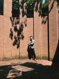 Full length of woman with shadow on tree