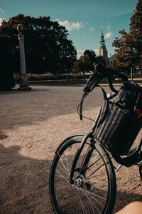 Bicycle on street in city against sky