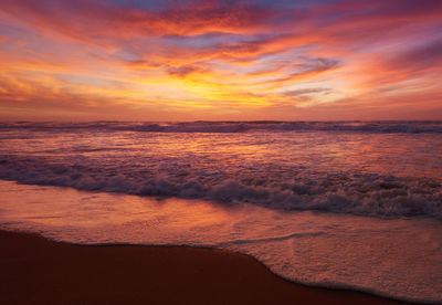 Scenic view of sea against orange sky