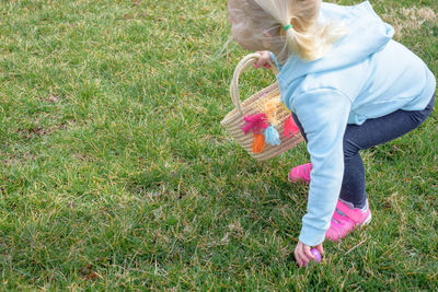 Low section of woman on grassy field