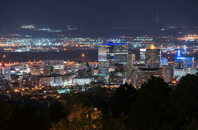 High angle view of city lit up at night