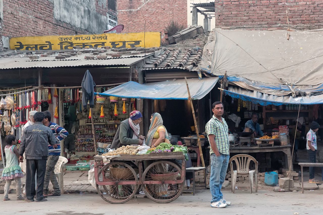 real people, small business, men, market, outdoors, day, market vendor, large group of people, retail, building exterior, full length, casual clothing, built structure, for sale, market stall, occupation, architecture, lifestyles, women, working, city, people