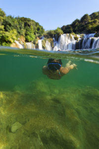 Diving under the waterfall of the krka river