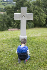 Rear view of boy on field