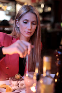 Portrait of young woman sitting at restaurant