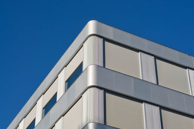 Low angle view of building against clear blue sky