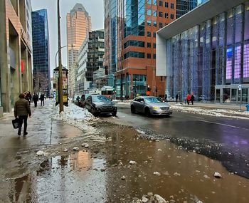 City street by buildings during rainy season