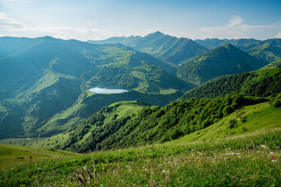 Scenic view of landscape and mountains against sky