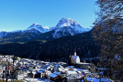 Scenic view of snowcapped mountains against clear blue sky