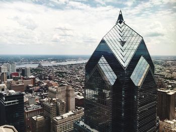 Skyscrapers against cloudy sky