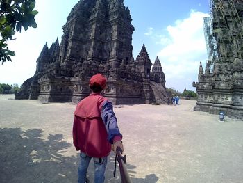 Rear view of man looking at temple