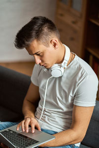 Young man using laptop at home