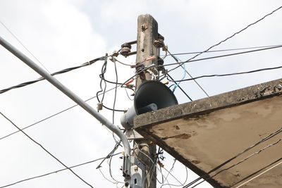 Low angle view of cables against sky