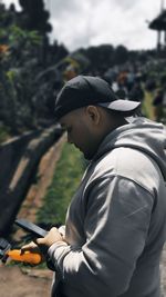 Side view of young man standing outdoors