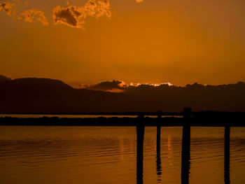 Scenic view of lake against orange sky