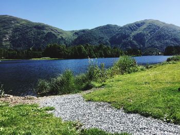 Scenic view of lake and mountains against sky