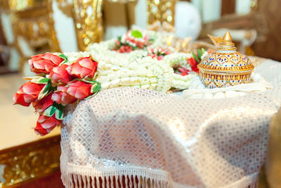 Close-up of garland and container on table at wedding