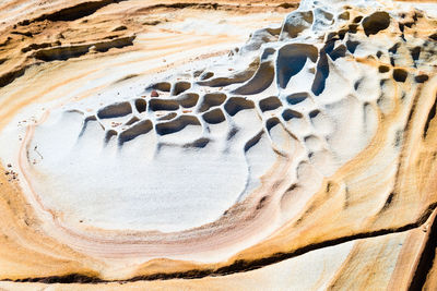 Close-up of heart shape on sand