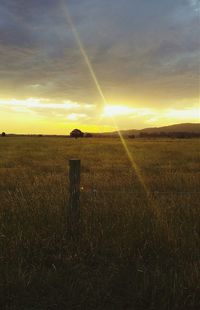 Scenic view of field against sky during sunset