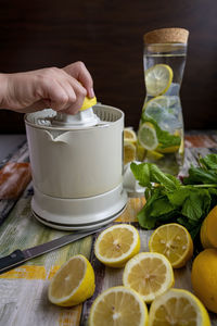 Preparation of fresh juices press on fresh lemon and lime. lemon squeezer machine or lemon presser.