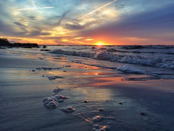 Scenic view of beach against sky during sunset