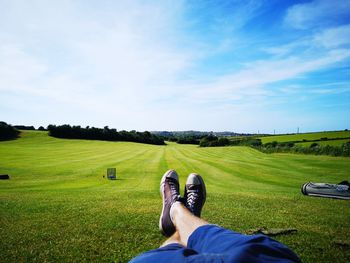 Low section of man sitting on land