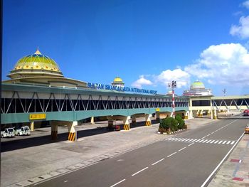 Road leading towards temple against sky