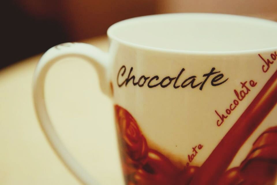 CLOSE-UP OF COFFEE CUP ON WHITE BACKGROUND