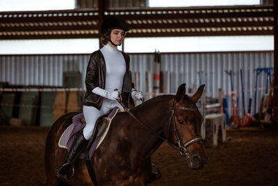 Young woman is engaged in equestrian sports