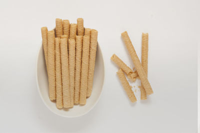 Close-up of bread over white background