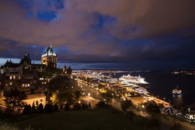 High angle view of city lit up at night