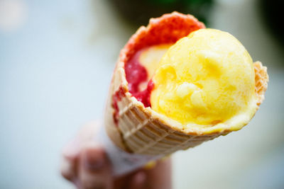 Close-up of hand holding ice cream