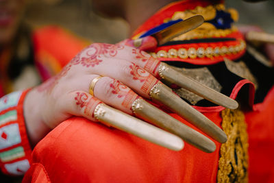 Close-up of bride hand on bridegroom shoulder during wedding ceremony