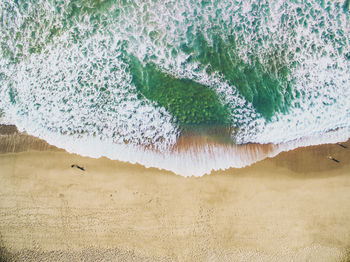 Aerial view of seashore during sunny day